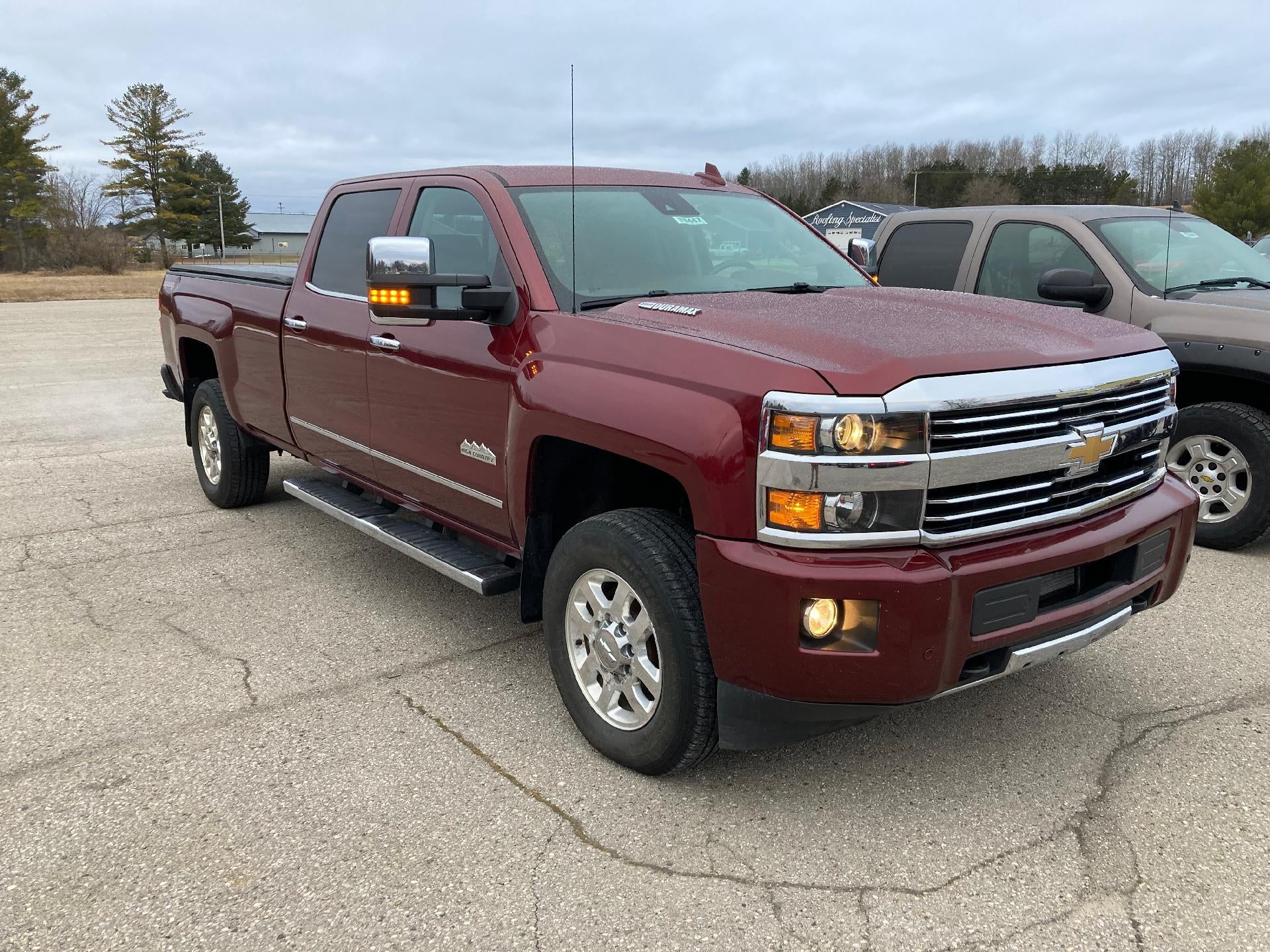 2015 Chevrolet Silverado 3500 HD High Country in Deep Ruby Metallic — front three-quarter view